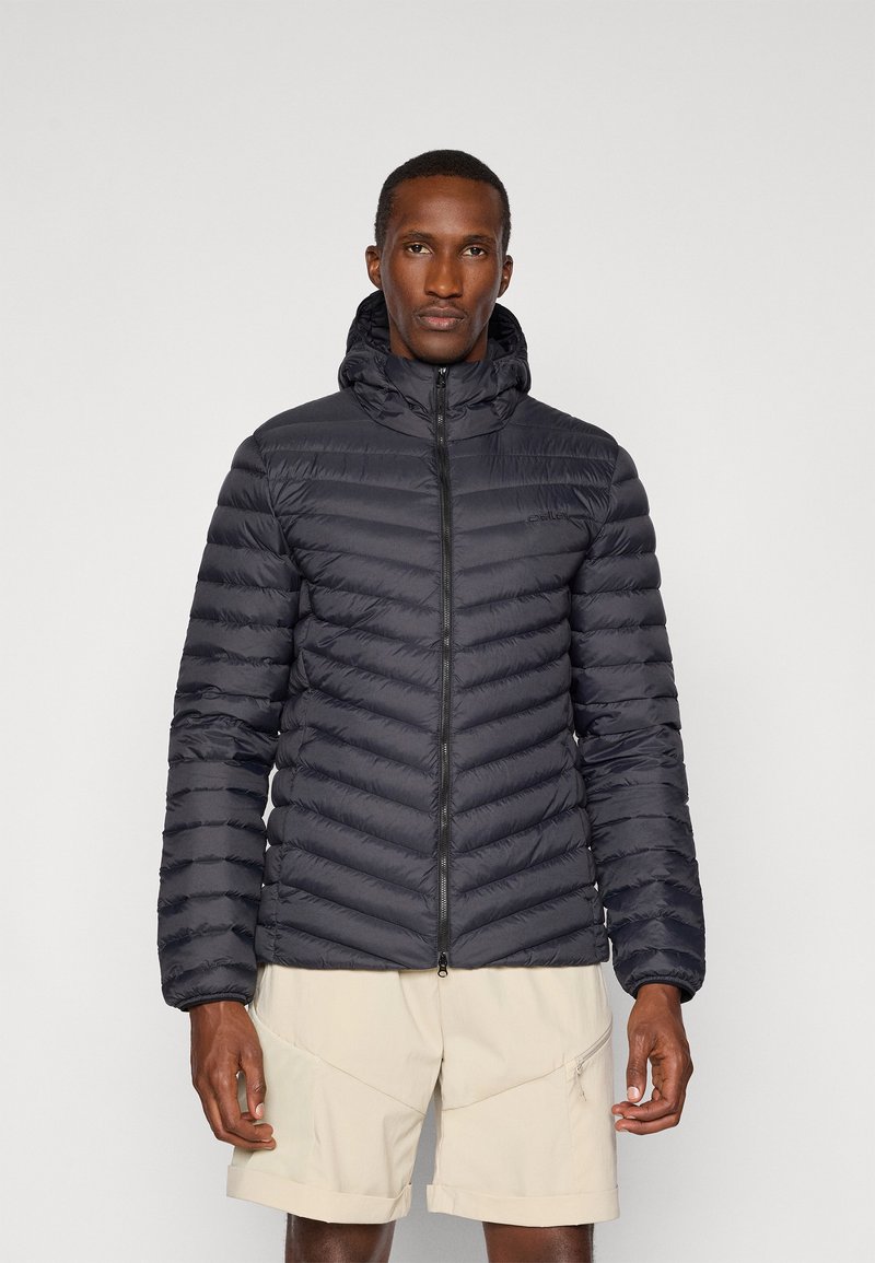 Black puffer jacket with a zip closure, hood, and horizontal quilted design. Worn over light beige shorts. Lightweight and insulated material.