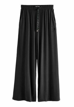 Black wide-leg pants with an elastic waistband, drawstring, side pockets, and an embroidered logo detail on the left side. Smooth texture.
