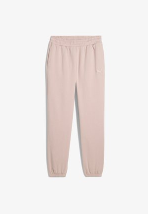 Svetloružové tepláky vyrobené z mäkkej tkaniny, s elastickým pásom, bočnými vreckami a zhromaždenými členkami so malým logom na boku.