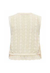 Gilet en maille sans manches de couleur crème avec motif en losanges et bordure à volants en dentelle ajourée à l'ourlet.