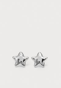 Silver star-shaped earrings with a polished finish and a brand logo. Smooth texture and symmetrical design.