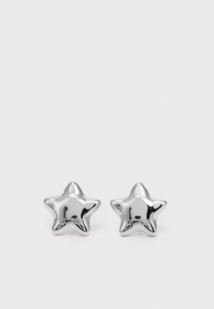 Silver star-shaped earrings with a polished finish and a brand logo. Smooth texture and symmetrical design.