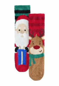 Mīksto svētku zeķu dizains ar Ziemassvētku vecīša motīvu sarkanā, baltā un zilā krāsu gammā, kā arī raga motīvu ar brūnām, sarkanām un zaļām akcentiem.