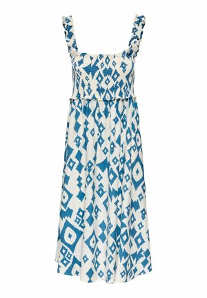 Robe midi blanche sans manches avec motifs géométriques bleus en forme de losange et bretelles à volants sur un corsage smocké.