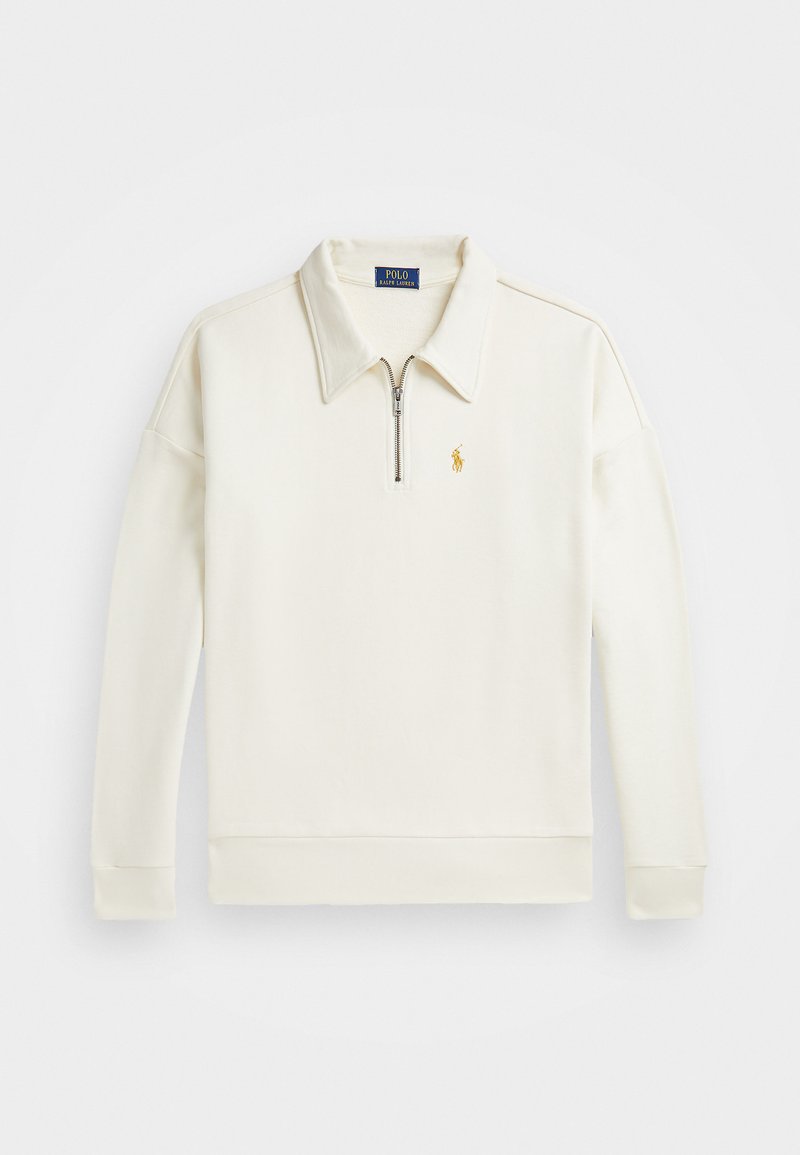 Polo majica s dugim rukavima u krem boji, s polu-zip ovratnikom, rebrastim manžetama i malim zlatnim logotipom na lijevoj strani prsnog koša. Glatka tekstura tkanine.