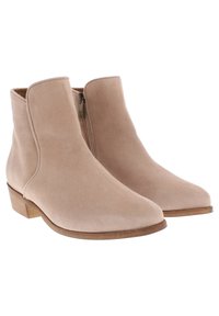 Beige mockasins med lågt blockklack, strömlinjeformad design och en sidodragkedja för enkel på- och avtagning; slät yta, minimalistisk stil.