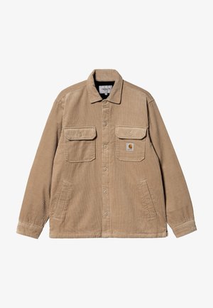 Beige corduroy jacket with two chest pockets, long sleeves, and button closure. Features a logo patch on the left pocket. Soft texture.