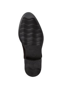 Sola di scarpa con un design in gomma nera ondulata e testurizzata, con una sezione liscia e un marchio. Forma arrotondata con una leggera elevazione del tacco.