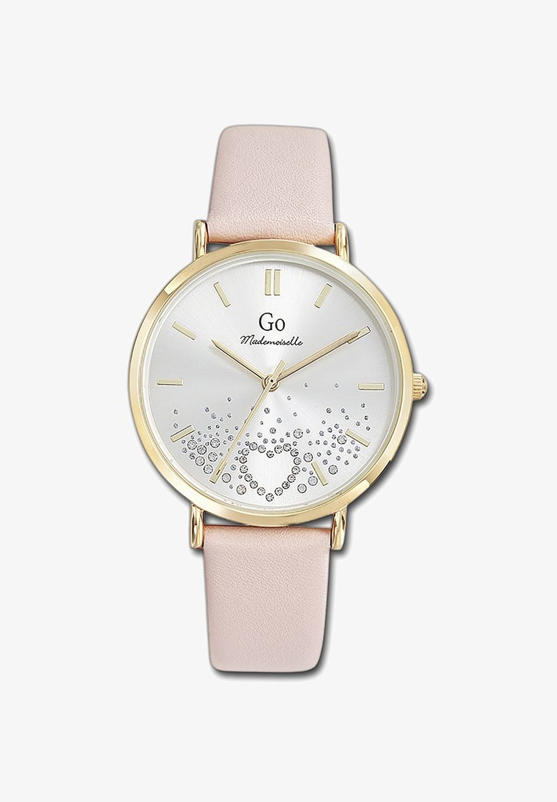 Montre en quartz dorée avec un cadran argenté, des accents en cristal formant un motif en cœur, et un bracelet en cuir rose clair. Design minimaliste.