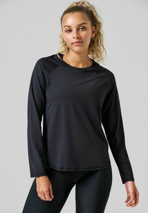 Zwarte lange mouwen sportshirt met een ronde hals en raglanmouwen, gemaakt van soepel, lichtgewicht materiaal met een iets getailleerd ontwerp.