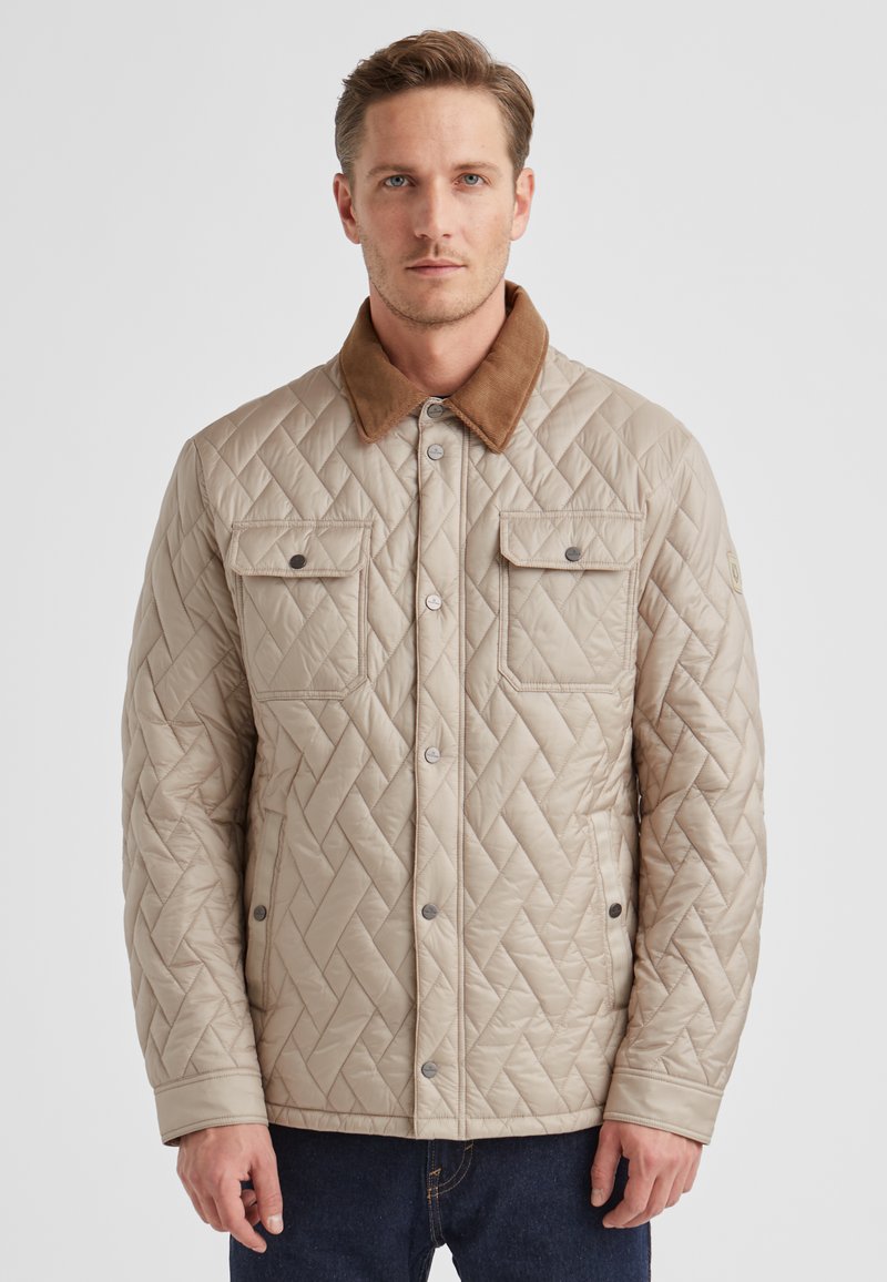 Beige gesteppte Jacke mit braunem Cordkragen, Druckknöpfen und zwei Brusttaschen. Glatte Textur mit Rautenmuster-Steppung.