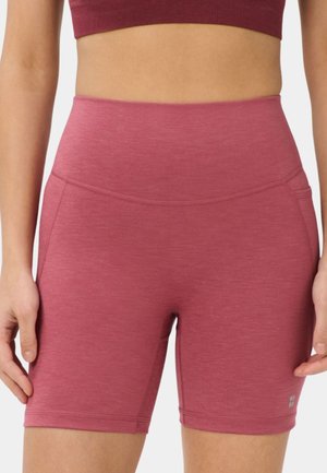 Woman wearing high-waist, knee-length rose pink active shorts with side pockets and fitted waistband, shown from hips to mid-thigh.
