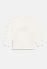 Back view of plain white long-sleeve toddler shirt with crew neckline, shown against a white background.