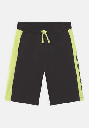 Short noir avec panneaux latéraux jaune fluo et cordon assorti, avec poches et texte graphique sur un côté.