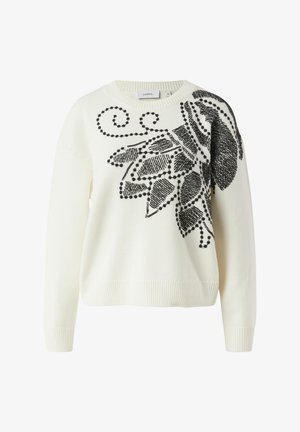 Maglione bianco lavorato a maglia con ampio motivo floreale nero e motivo a spirale. Polsini e orlo a coste con scollo rotondo.