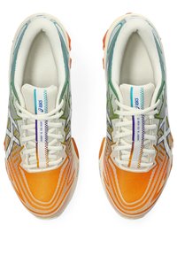 Running shoes with a white mesh upper, gradient green to orange accents, and a textured orange toe box. Features multi-colored lace loops and branding.