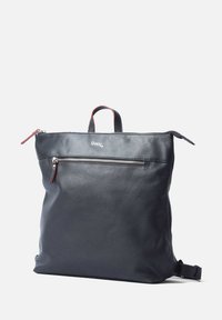 Black leather backpack with a smooth texture, zippered front pocket, short handles, and adjustable strap. Subtle red accent on the zipper.
