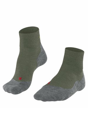 Chaussettes de cheville vert olive avec un revers côtelé et un orteil gris sans couture. Présente un petit logo rouge sur le côté et un talon et une pointe renforcés.