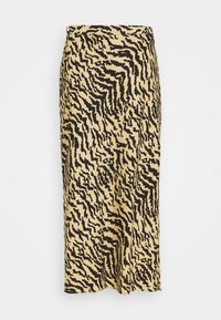 Savannah-inspirerad midi kjol i beige med svarta zigzag-mönster. Har en slät yta och en rak skärning, som slutar vid mitt vad.