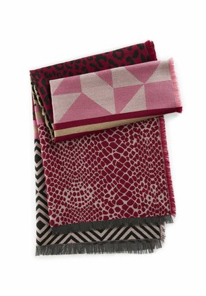 Écharpe pliée avec des motifs géométriques, animaliers et abstraits en rouge, rose et beige, avec des bords à franges sur un fond blanc.