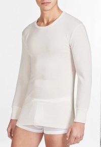 Maglietta termica a maniche lunghe in bianco sporco, realizzata in tessuto rigato leggero. Presenta un collo rotondo e una vestibilità aderente.