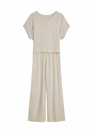 Beżowy dwuczęściowy kombinezon z krótkim, wykrojonym rękawem i szerokimi spodniami. Wykonany z lekkiego materiału, o luźnym kroju i z regulowanym pasem.