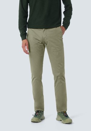 Light green, straight-leg pants made of cotton with a smooth texture. Features side pockets and is paired with a dark green sweater and green shoes.