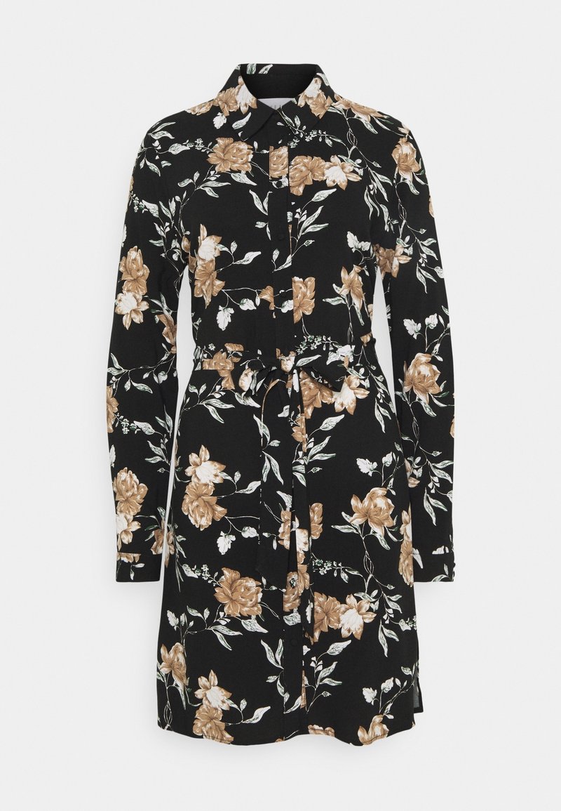 Robe-chemise noire à manches longues avec imprimé floral marron et blanc, boutonnée devant, col et ceinture nouée à la taille.