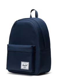 Navy blue backpack made of durable fabric with a rounded top, a front pocket, and branded label. Features a top handle and adjustable straps.