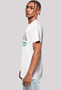 White cotton t-shirt featuring a colorful graphic print on the front. Short sleeves, crew neck, and a slightly relaxed fit.