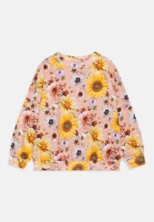 Sweat-shirt rose à manches longues avec un motif de grandes fleurs de tournesol, de marguerites et d'autres fleurs variées aux tons jaunes, blancs et violets.