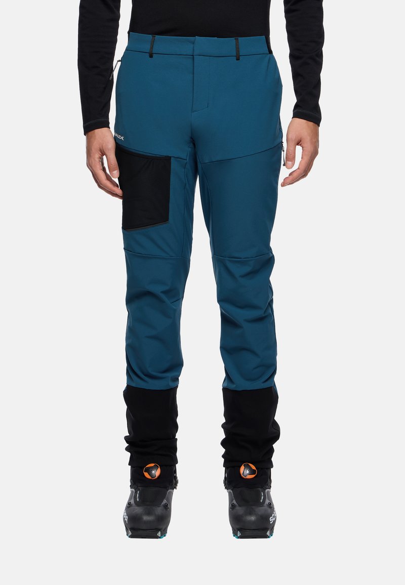 Teal ski-broek met een zwarte zak, elastische manchet en waterdicht materiaal. Ontworpen voor actieve buitensportactiviteiten. Heeft een getailleerde pasvorm.