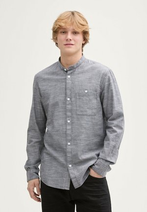 Gray, long-sleeve button-up shirt with a band collar, single chest pocket, and white buttons; textured fabric. Worn with black pants.
