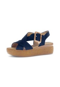 Marineblauwe suède sandalen met kruislings banden, verstelbare gesp en een geweven jute platformzool. Lichtgewicht ontwerp met een lichte hakverhoging.