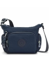 Navy blue nylon crossbody bag with adjustable strap, zippered pockets, rubber logo patch, and a monkey keychain attachment.