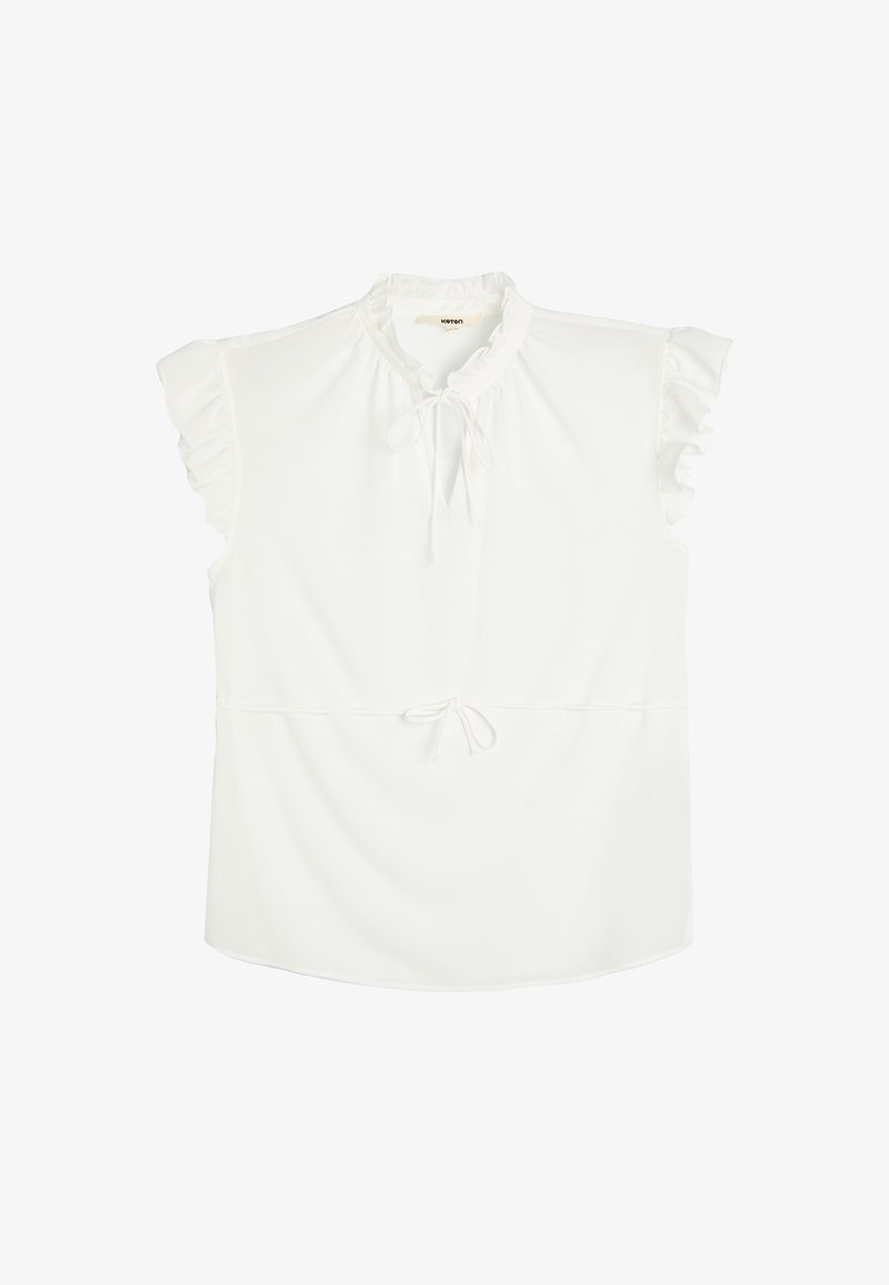 Top bianco con maniche corte a volant, scollatura arricciata e vita con coulisse. Realizzato in un tessuto morbido con una vestibilità leggermente ampia.