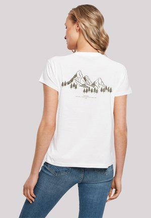 T-shirt blanc à manches courtes avec un motif de montagne et d'arbre en noir et vert au dos. Le tissu semble doux et décontracté.