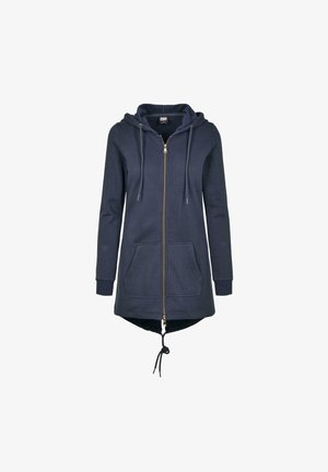 Tumesinine kapuutsiga veste, millel on ees lukk, kaks külgtaskut ja reguleeritav nöör alläärs. Pehme, tekstuuriga kangas.