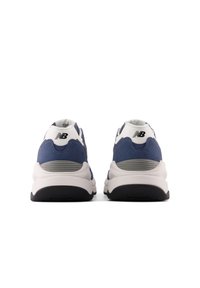 Blue and white athletic shoes feature a textured upper, padded collar, and a thick white midsole with black outsole for traction.