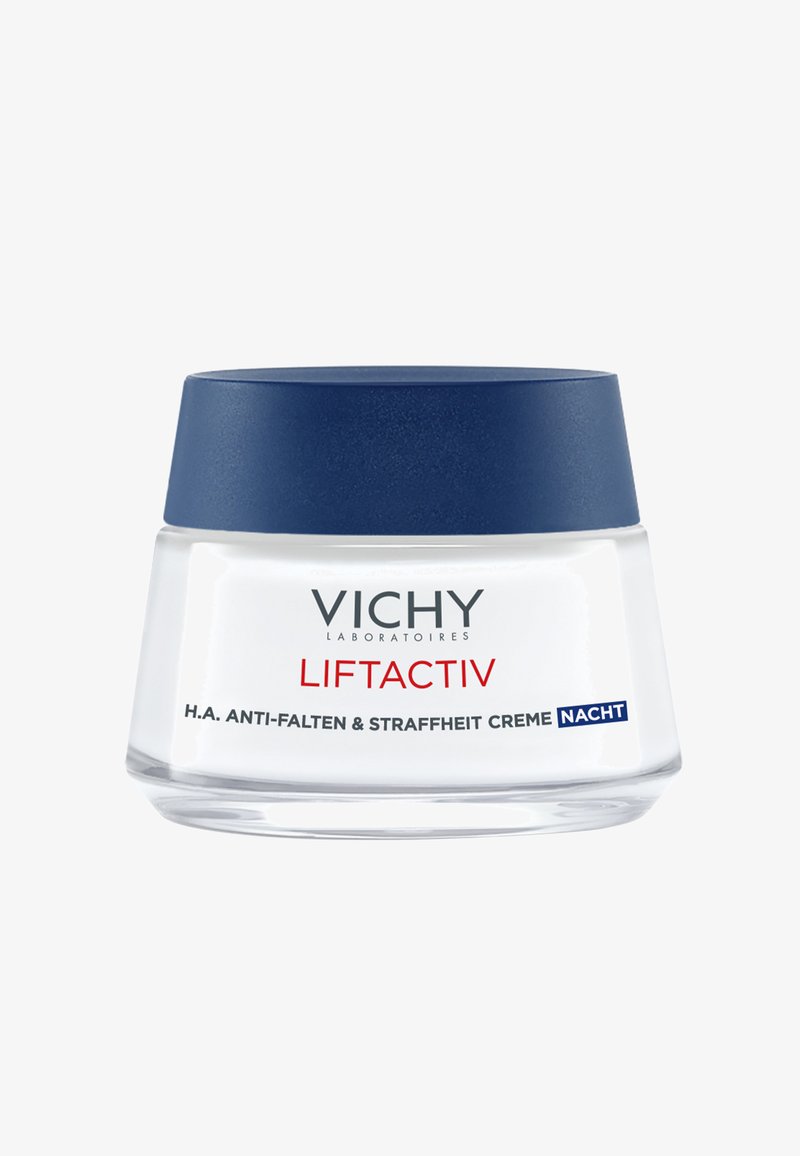 Weißes Glasgefäß mit einem marineblauen Deckel, beschriftet mit "Vichy Liftactiv H.A. Anti-Falten & Straffheit Creme Nacht." Glatte Textur, minimalistisches Design.