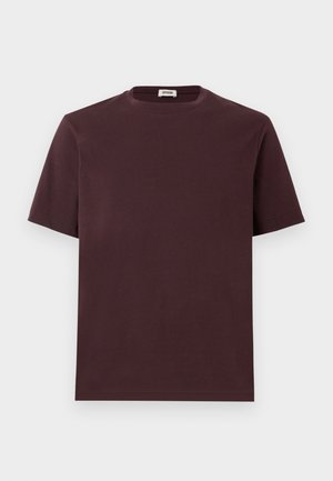 Burgundy cotton T-shirt with a round neckline, short sleeves, and a relaxed fit. No visible logos or patterns. Soft texture.