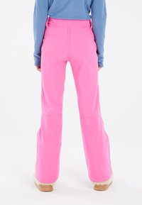 Roze sneeuwbroeken met een uitlopende pasvorm, gemaakt van rekbaar materiaal. Voorzien van stiksels en een hoge taille, gecombineerd met comfortabele schoeisel.