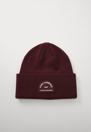 Burgundy knit beanie with a folded cuff. Features a rectangular patch with "Karl Lagerfeld Paris" and "21 Rue St-Guillaume" in white text.
