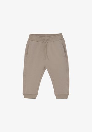 Jogging léger beige fabriqué en tissu doux, avec une taille élastique à cordon, deux poches latérales et des poignets ajustés.