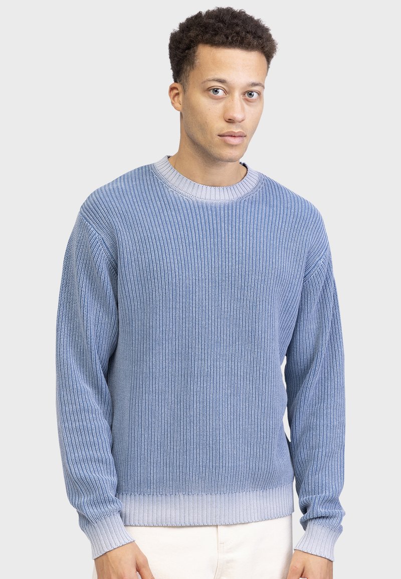 Light blue knitted sweater with a ribbed texture, round neckline, and long sleeves, featuring a contrasting lighter ribbed hem.