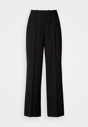 Mustad laiad püksid kõrge vöökohaga, millel on peene täpikaga muster, volditud esiosa ja sile kangatekstuur.