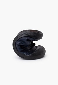 Navy foldable shoe featuring a textured black rubber sole, smooth leather upper, and compact design for easy storage.