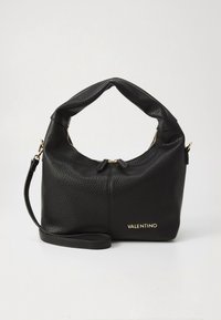 Black leather handbag with a textured finish, a curved handle, and a detachable shoulder strap. Features gold hardware and branding.