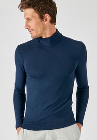 Marineblauwe coltrui van een soepele, rekbare stof; met lange mouwen en een aansluitend ontwerp zonder patronen of hardware.