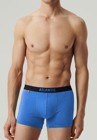 Niebieskie slipki bokserki z czarnym paskiem, na którym znajduje się napis "ATLANTIC" w niebieskim kolorze. Wykonane z gładkiego, elastycznego materiału o dopasowanym kroju.